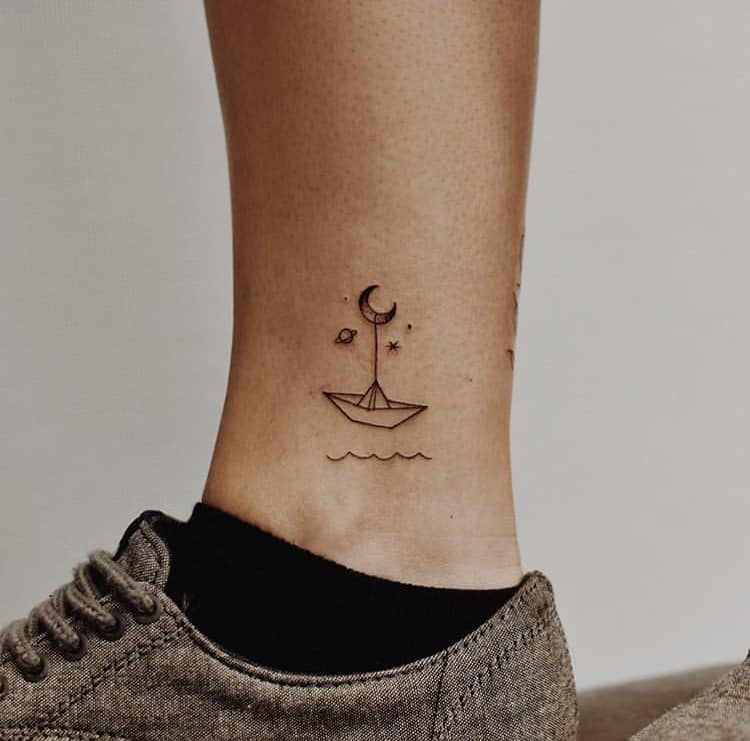 Moon and small boat minimalist tattoo design