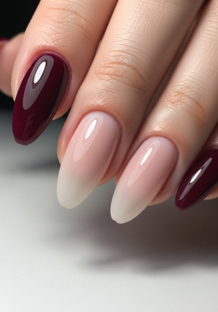 Nails with burgundy to nude ombre gradient, smooth transition with glossy finish