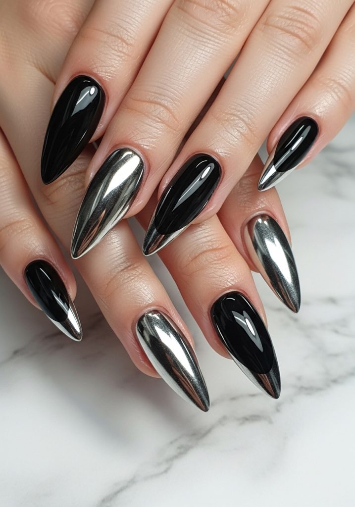 Long stiletto prom nails with a jet black base and striking silver chrome French tips