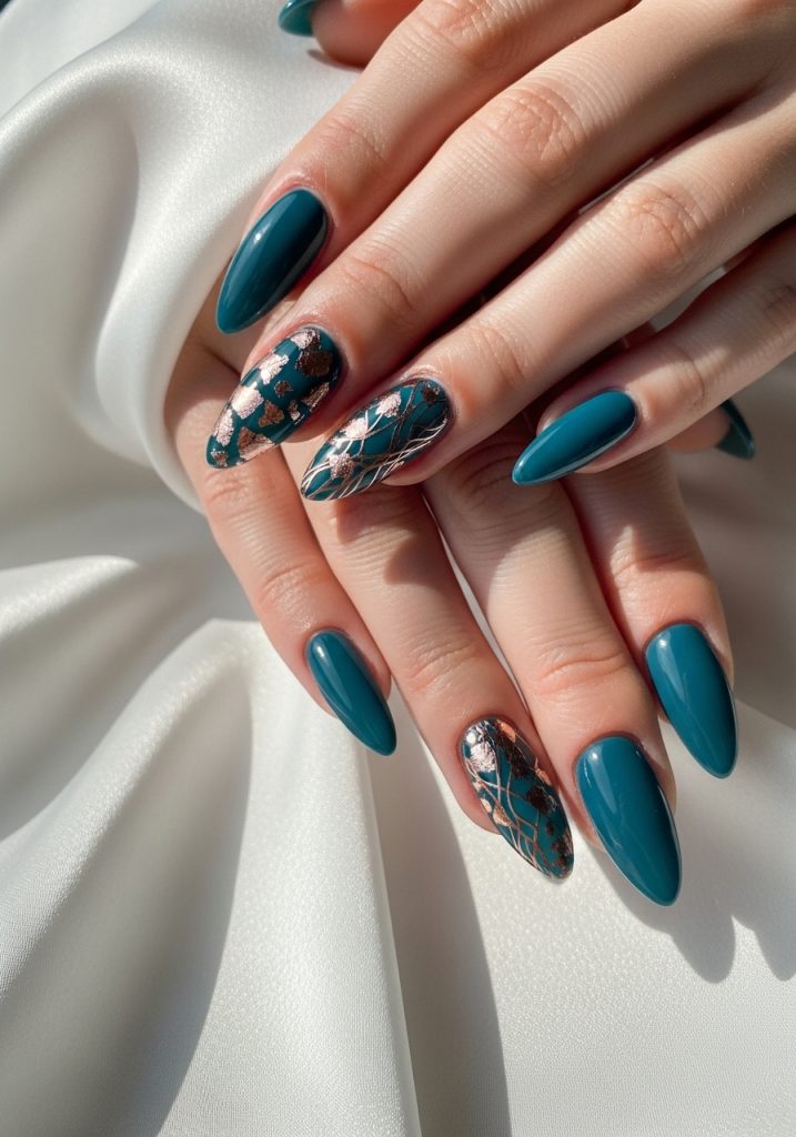 Medium stiletto-shaped dark teal prom nails with delicate rose gold foil accent nail art