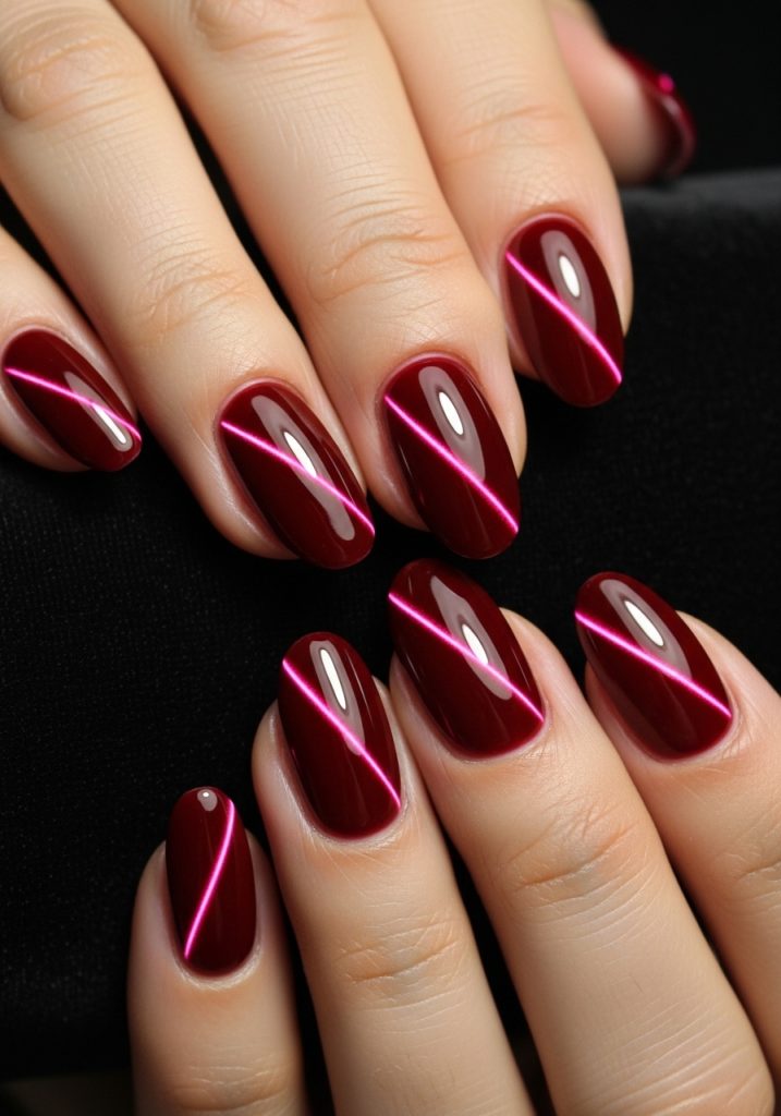 Medium oval-shaped deep red cat eye magnetic gel prom nails with dramatic light-catching streaks