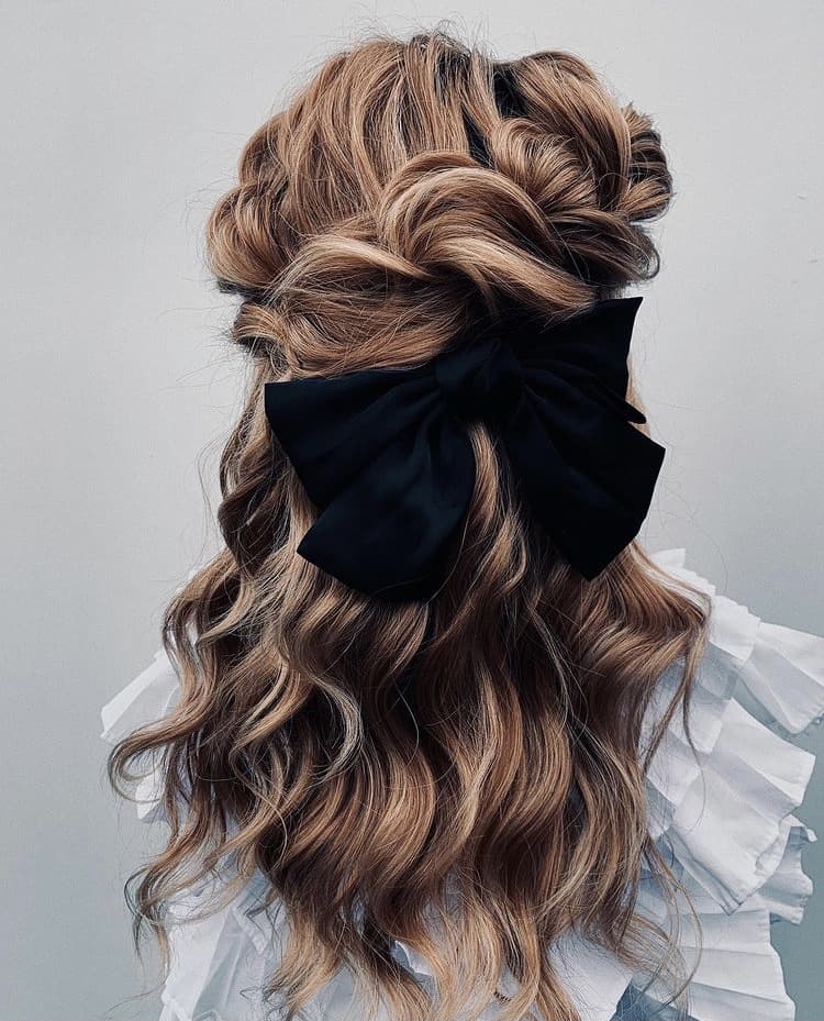 Half-up hairstyle with a bow