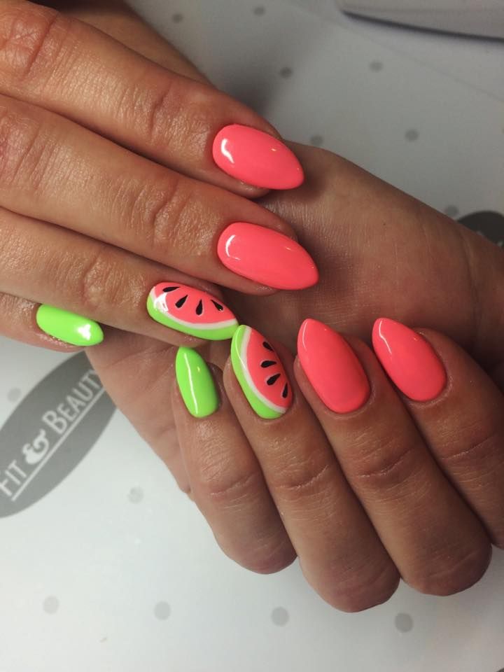 Close-up of hands with varied nail polish, including neon coral, bright green, and two nails with watermelon slice designs.