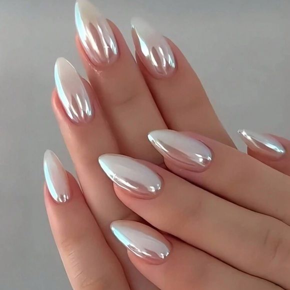 Close up of manicured hands with iridescent chrome almond-shaped nails.